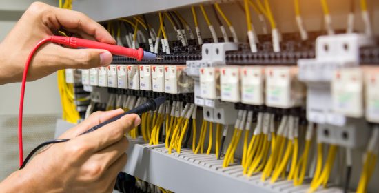 electricians-hands-testing-current-electric-control-panel