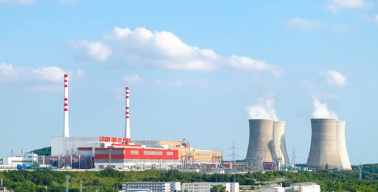 panoramic-view-nuclear-power-plant-with-steaming-cooling-towers-blue-sky